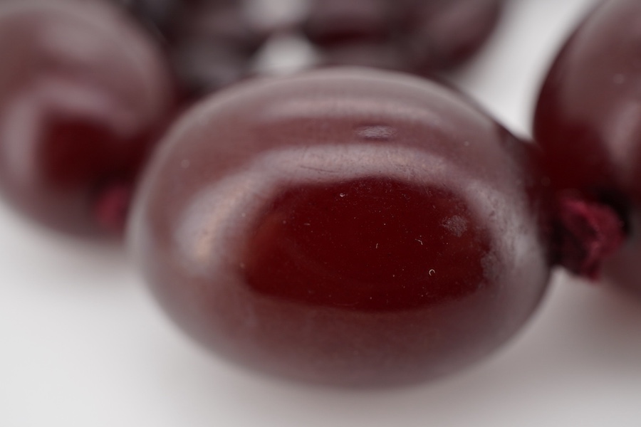 A single strand simulated cherry amber bead necklace, with graduated oval beads, 72cm, gross weight 73 grams.